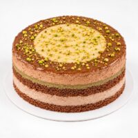 Layered chocolate and pistachio cake topped with pistachios